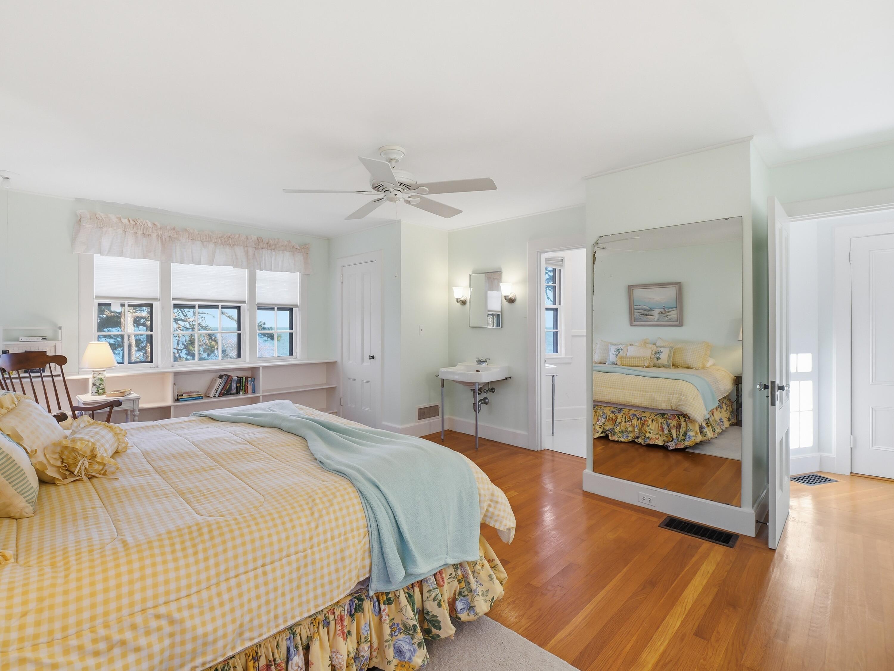 190 Vineyard Road Cotuit, MA 02635 - Photo 23 of 41 a spacious bedroom with a bed and a large window