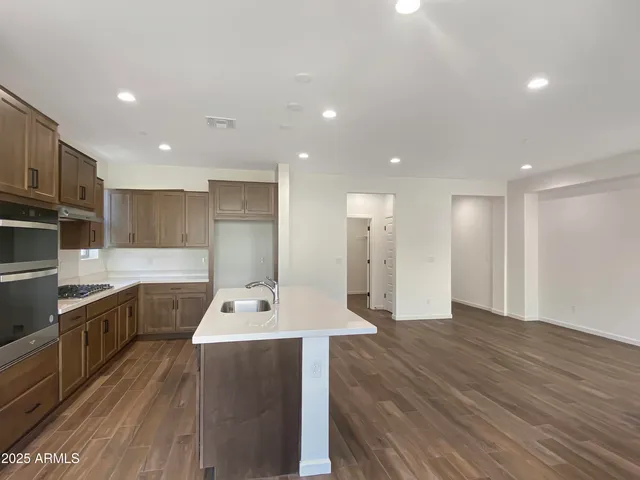 a kitchen with a sink appliances and cabinets