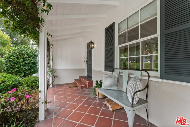 a view of balcony with two chairs and a potted plant