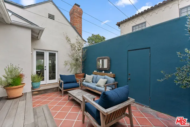 a outdoor space with patio the couch and potted plants
