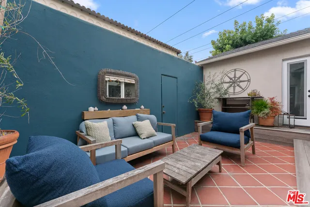 a outdoor living room with furniture and wooden floor
