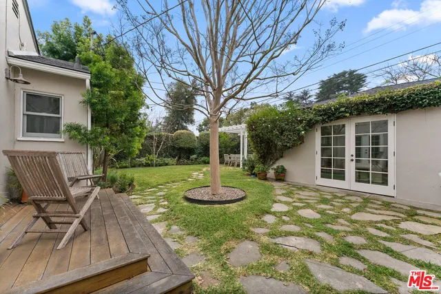 a view of a house with backyard and sitting area