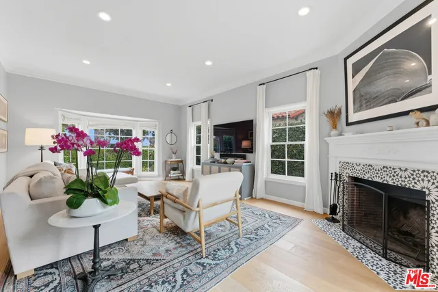 a living room with furniture fireplace and flat screen tv