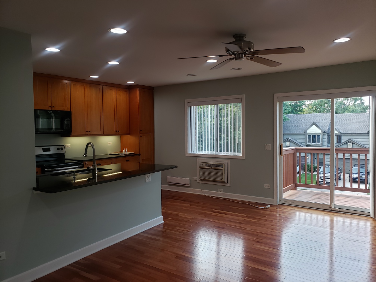 705 Strom Drive, Unit 2A West Dundee, IL 60118 - Photo 3 of 13 a kitchen with stainless steel appliances granite countertop a sink stove and wooden floor