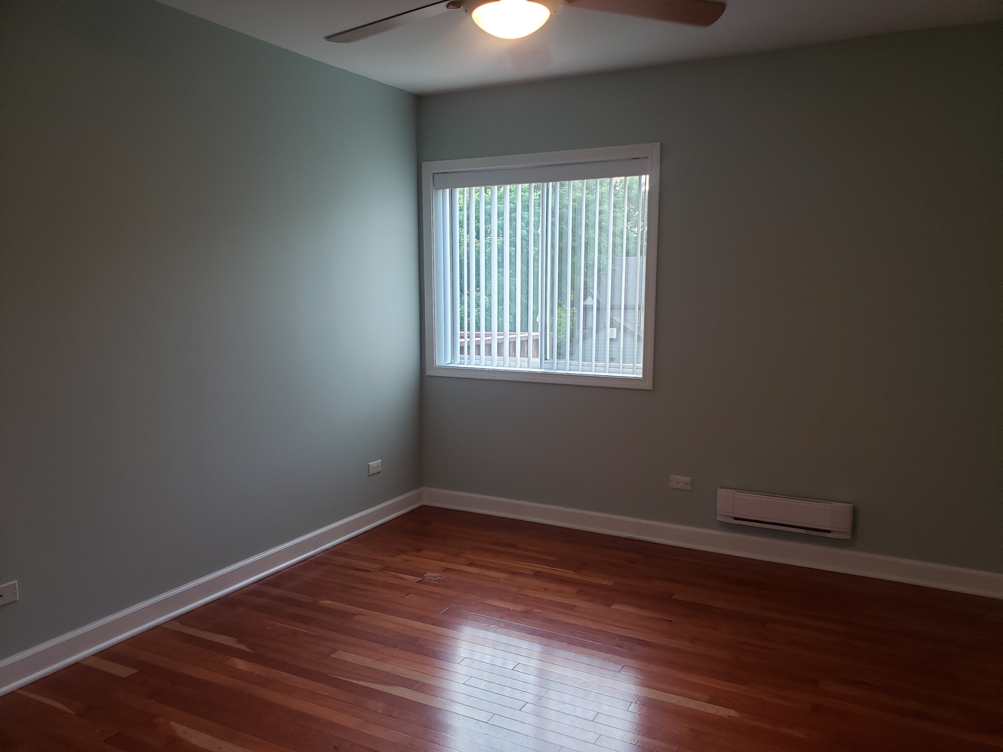 705 Strom Drive, Unit 2A West Dundee, IL 60118 - Photo 7 of 13 a view of an empty room with wooden floor and a window