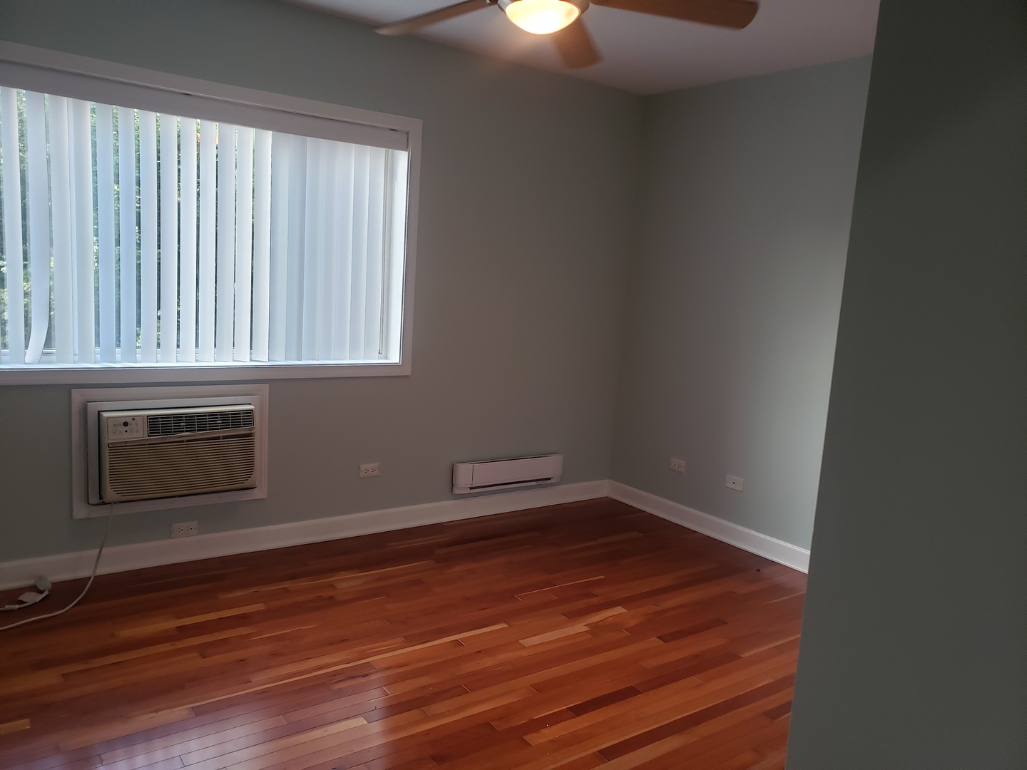 705 Strom Drive, Unit 2A West Dundee, IL 60118 - Photo 9 of 13 a room with a wooden floor and windows