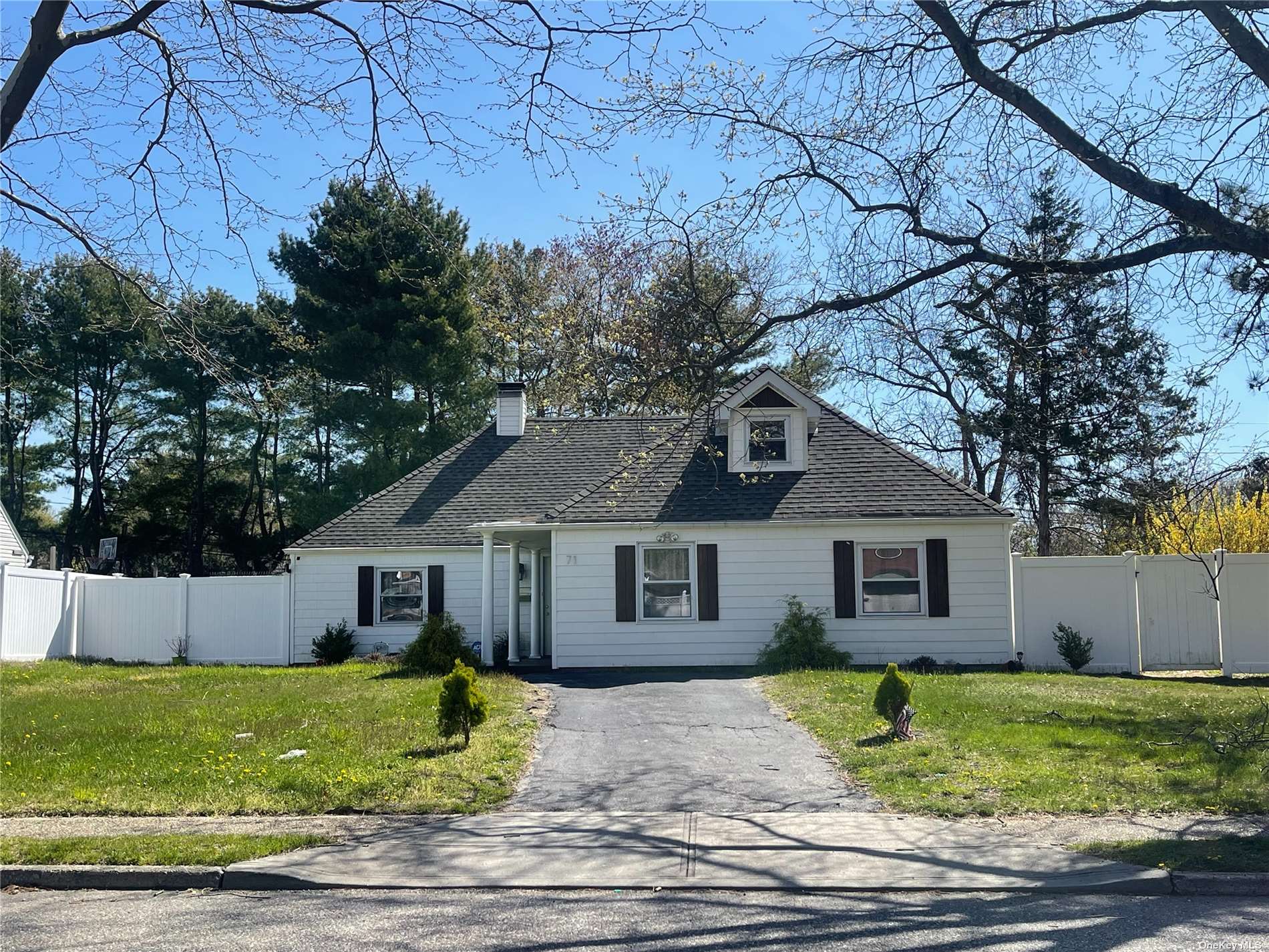 71 Split Cedar Drive Islandia, NY 11749 - Photo 1 of 1 a front view of a house with a garden and yard