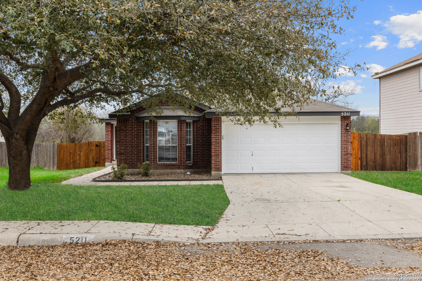 5211 Stormy Autumn San Antonio, TX 78247 - Photo 1 of 24 a front view of a house with a yard and garage