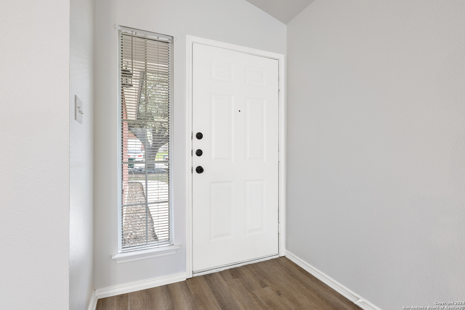5211 Stormy Autumn San Antonio, TX 78247 - Photo 3 of 24 an empty room with wooden floor and windows