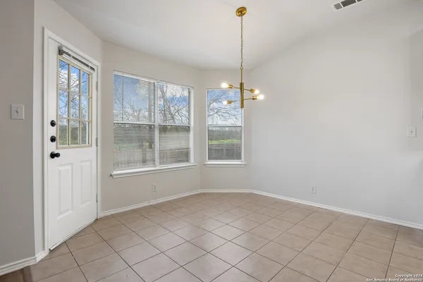 a view of an empty room with windows