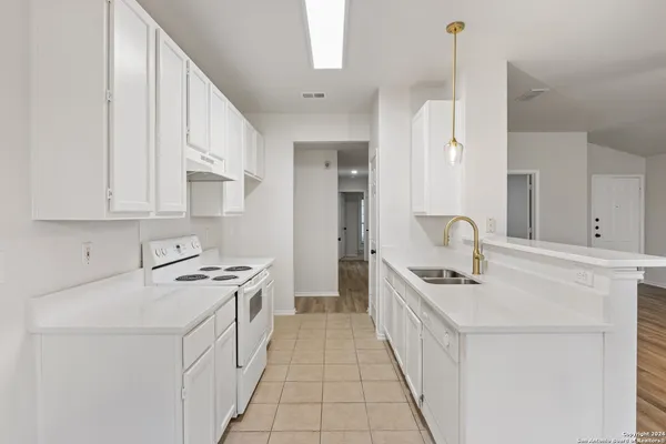 a kitchen with stainless steel appliances a sink stove and cabinets