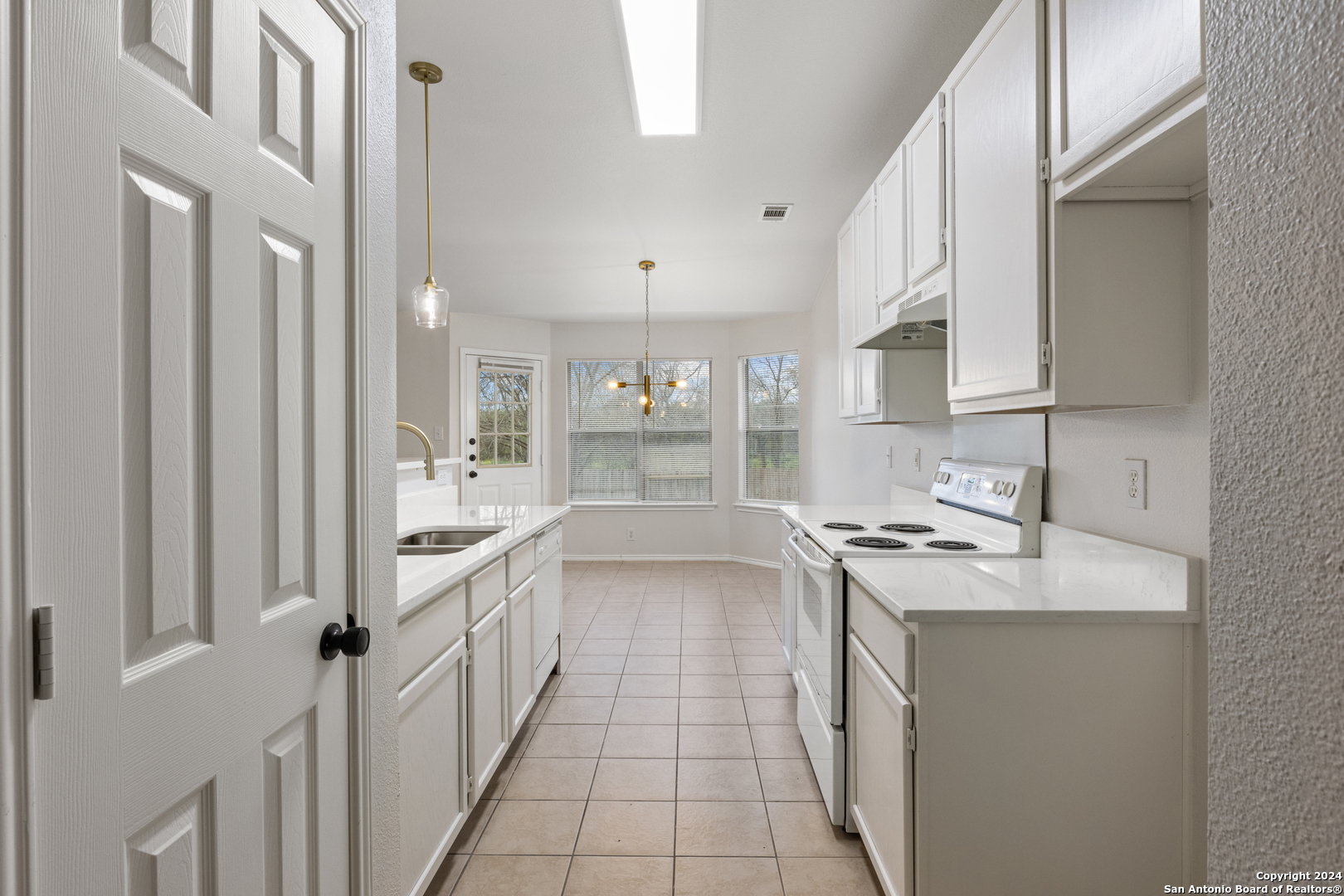 5211 Stormy Autumn San Antonio, TX 78247 - Photo 9 of 24 a kitchen with a sink stove and cabinets