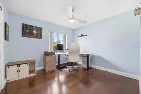 a view of a workspace with furniture and a window