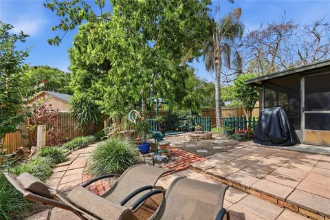a view of a chairs and table in backyard