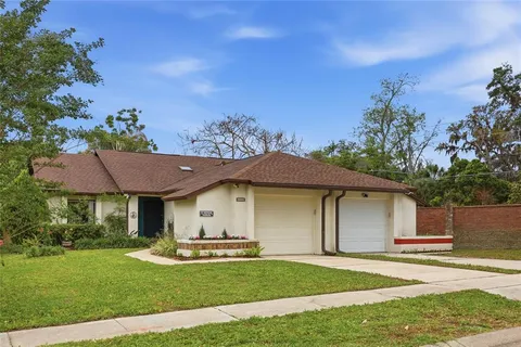 a front view of a house with a garden and outdoor seating