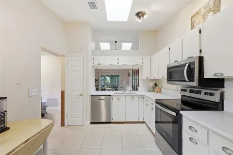 a kitchen with a sink stove and microwave