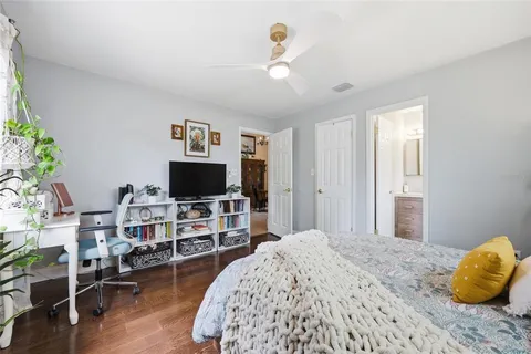a bedroom with furniture and a flat screen tv