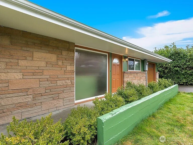 17930 Military Road South SeaTac, WA 98188 - Photo 2 of 19 a front view of a house with garden