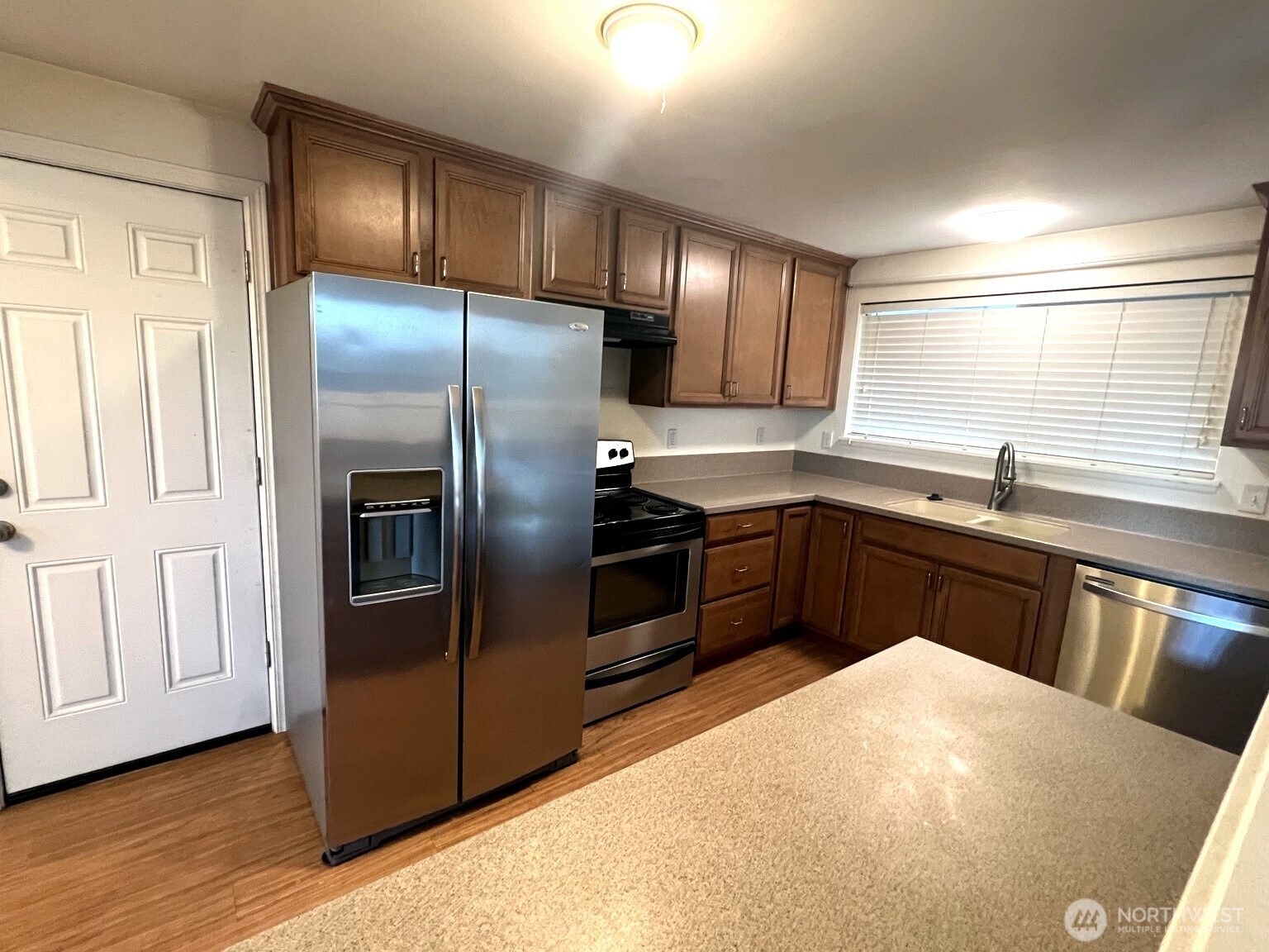 17930 Military Road South SeaTac, WA 98188 - Photo 3 of 19 a kitchen with stainless steel appliances granite countertop a sink a stove and a refrigerator