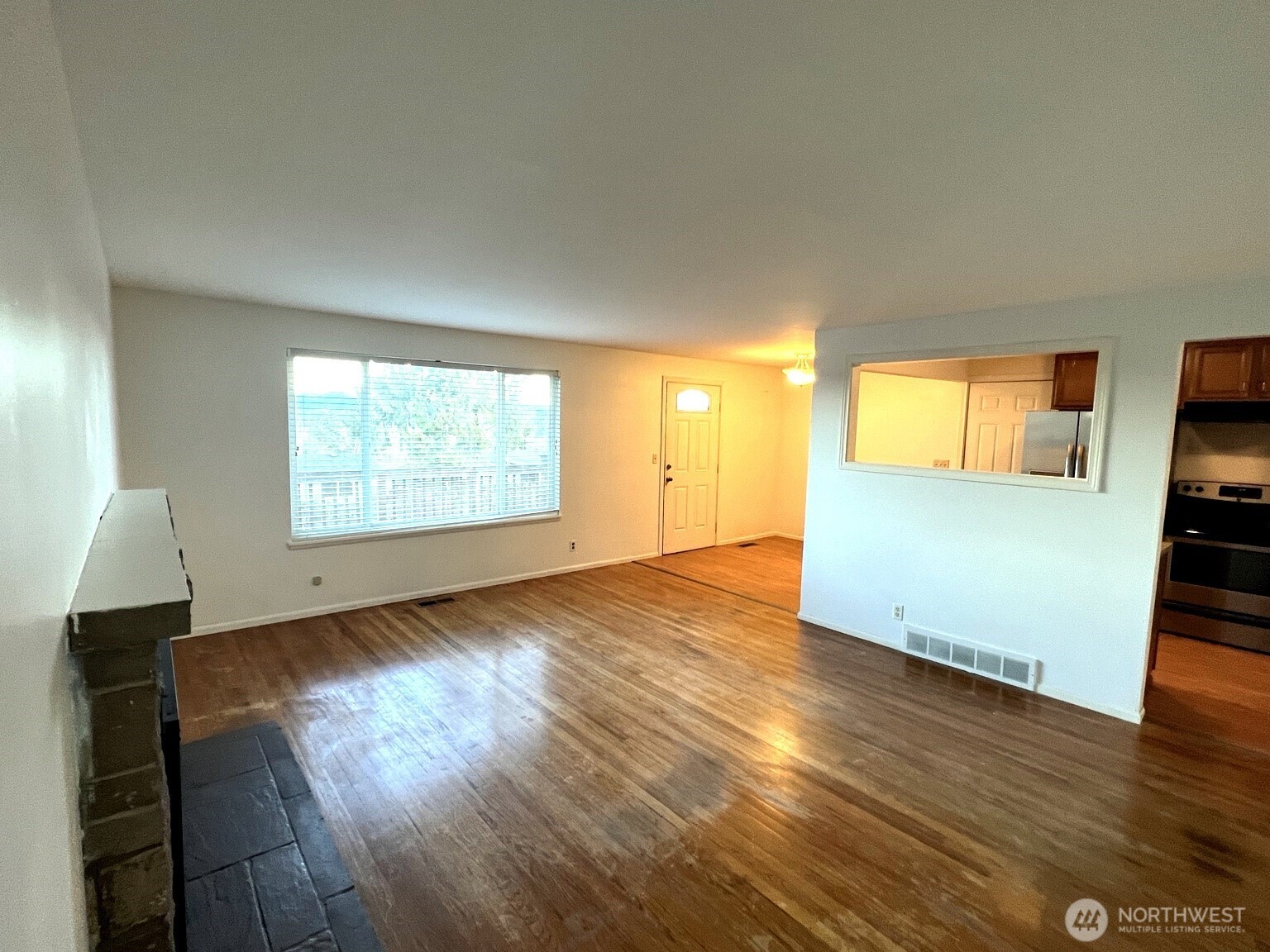 17930 Military Road South SeaTac, WA 98188 - Photo 7 of 19 an empty room with wooden floor and windows