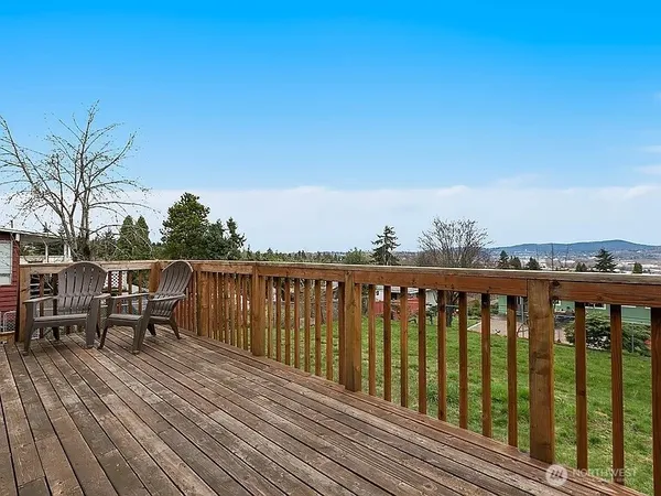 a view of a balcony with wooden floor and bench