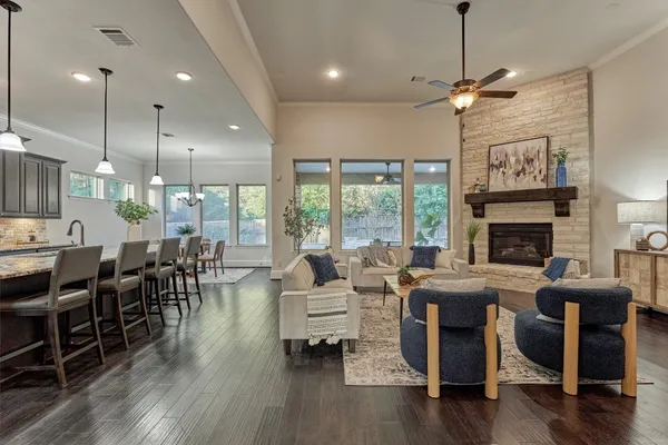 a living room with fireplace furniture and a wooden floor