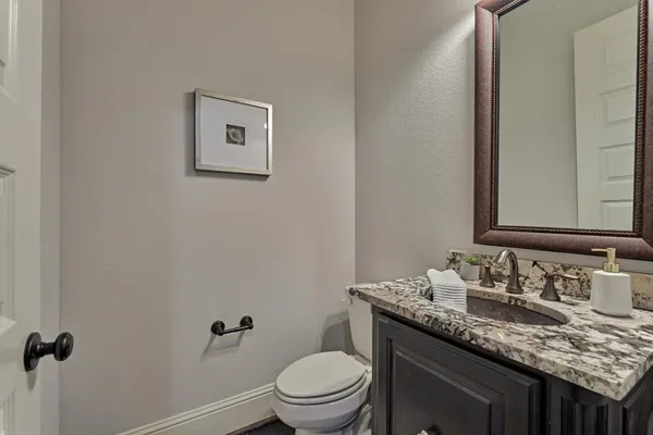 a bathroom with a shower sink vanity mirror and toilet