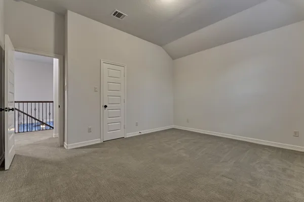 an empty room with a cabinet and mirrors