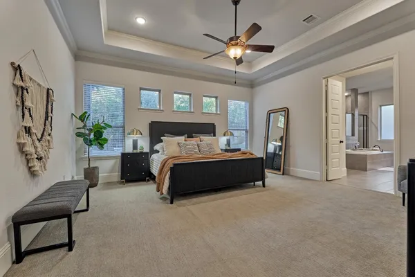 a bedroom with a bed and a chandelier