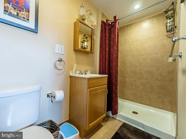 a bathroom with a toilet and a mirror