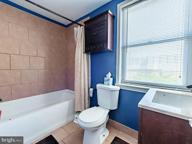a bathroom with a toilet a sink and a mirror