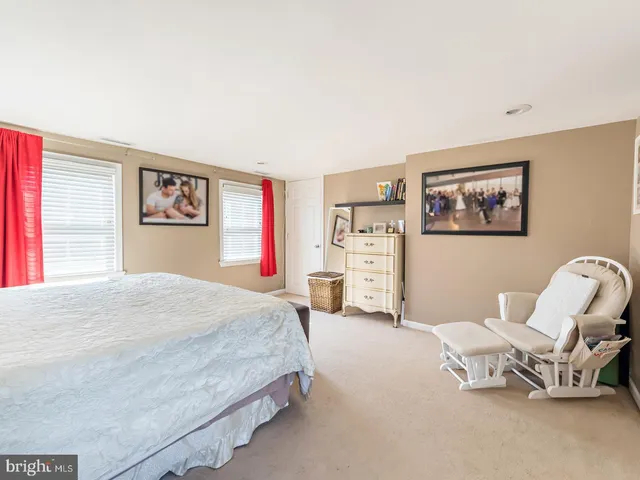 a spacious bedroom with a bed and a couch