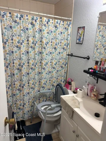 a bathroom with a sink toilet and a shower