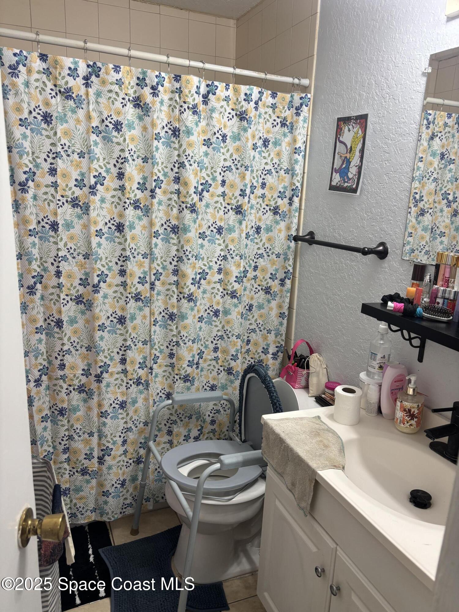 514 Donley Street Cocoa, FL 32922 - Photo 12 of 22 a bathroom with a sink toilet and a shower