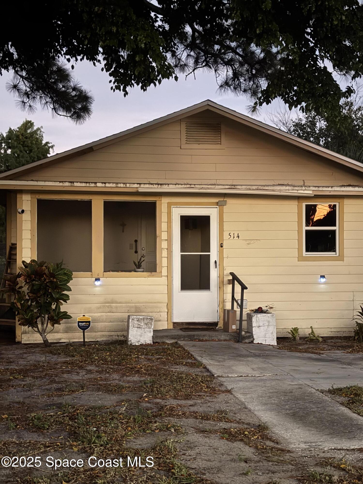 514 Donley Street Cocoa, FL 32922 - Photo 2 of 22 a front view of a house with a yard