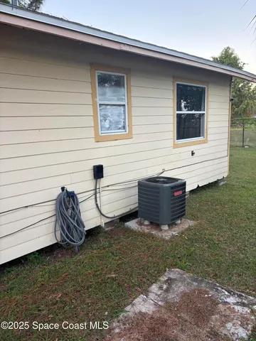 a view of backyard of house and outdoor seating