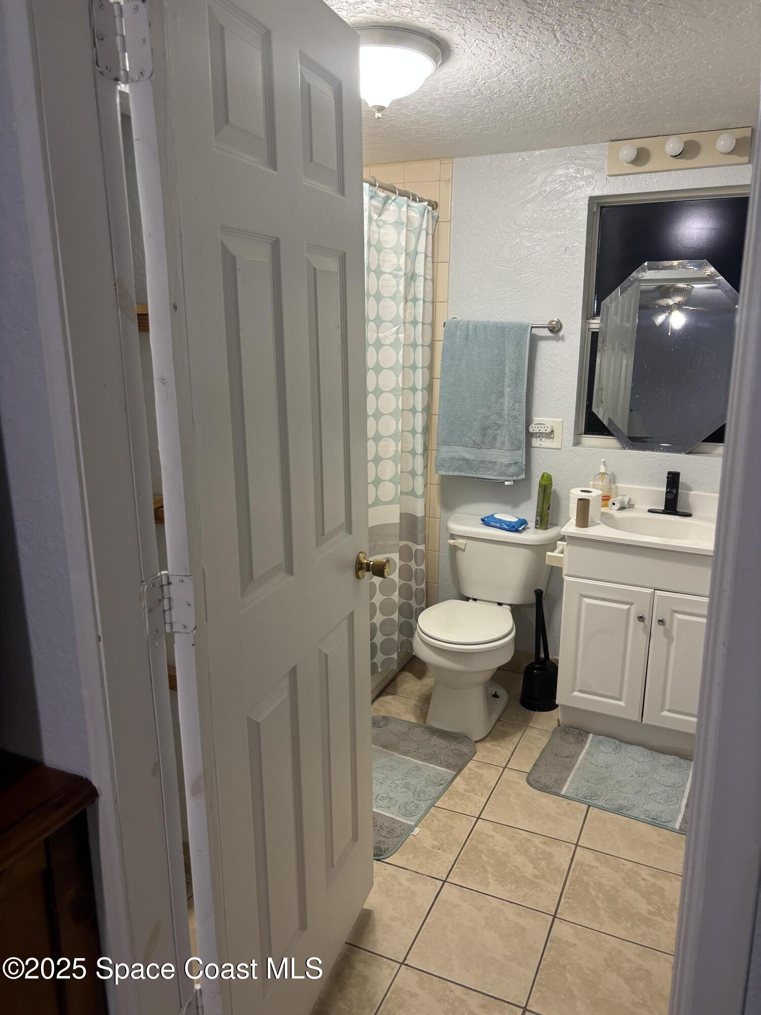 514 Donley Street Cocoa, FL 32922 - Photo 5 of 22 a bathroom with a toilet sink and mirror