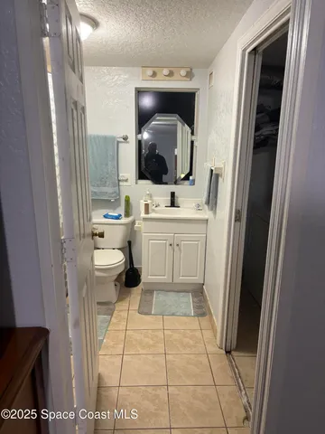 a bathroom with a toilet a sink and a mirror