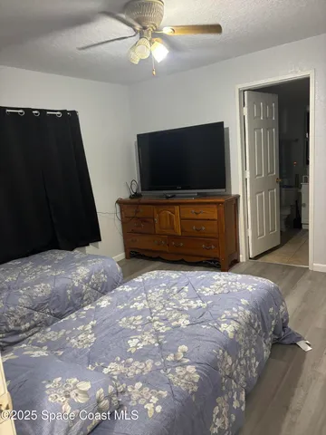 a bedroom with a bed and flat screen tv