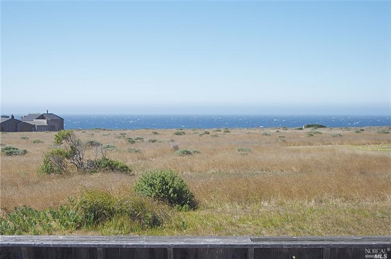 Panoramic view across common area.  A short walk to the bluff trail for  hiking and beach access.  Sweet home sited in a quiet cul de sac near gold, swimming, tennis and close to town. Purchase includes lot next door for future investment and to secure view from house.