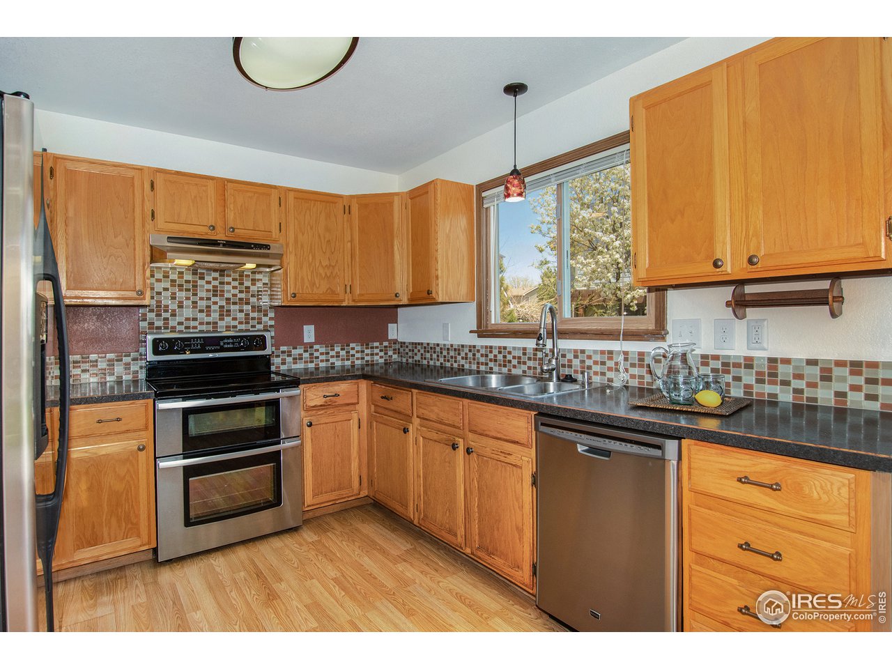 1706 Rutledge Court Fort Collins, CO 80526 - Photo 7 of 20 Stainless appliances & counter-depth refrigerator.