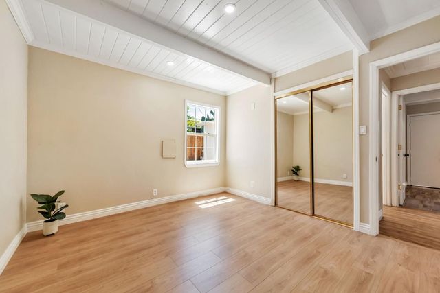 a view of a room with wooden floor and white walls