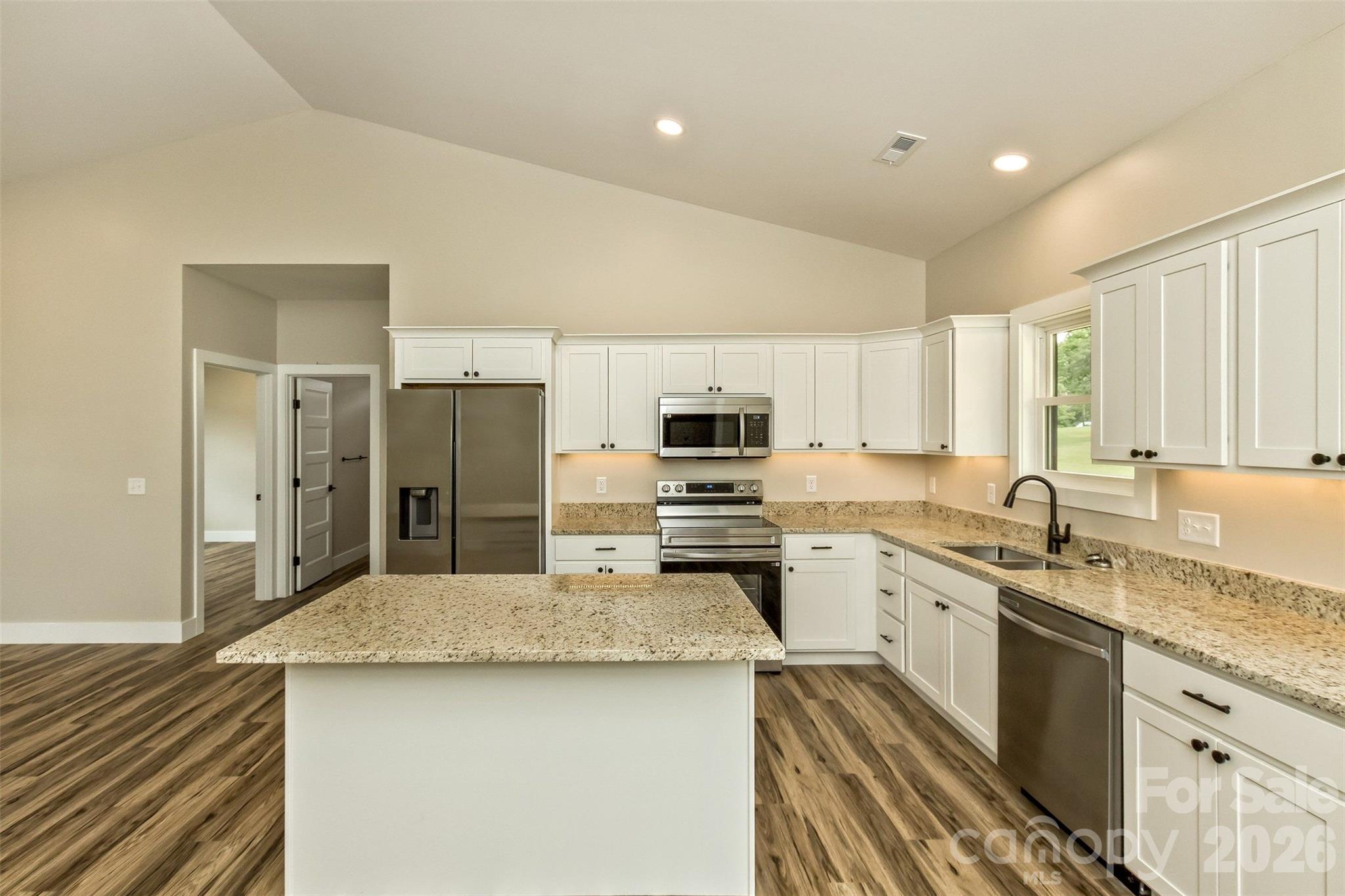 112 Peyton Elaine Road Clyde, NC 28721 - Photo 7 of 35 a kitchen with stainless steel appliances granite countertop a sink stove refrigerator and cabinets