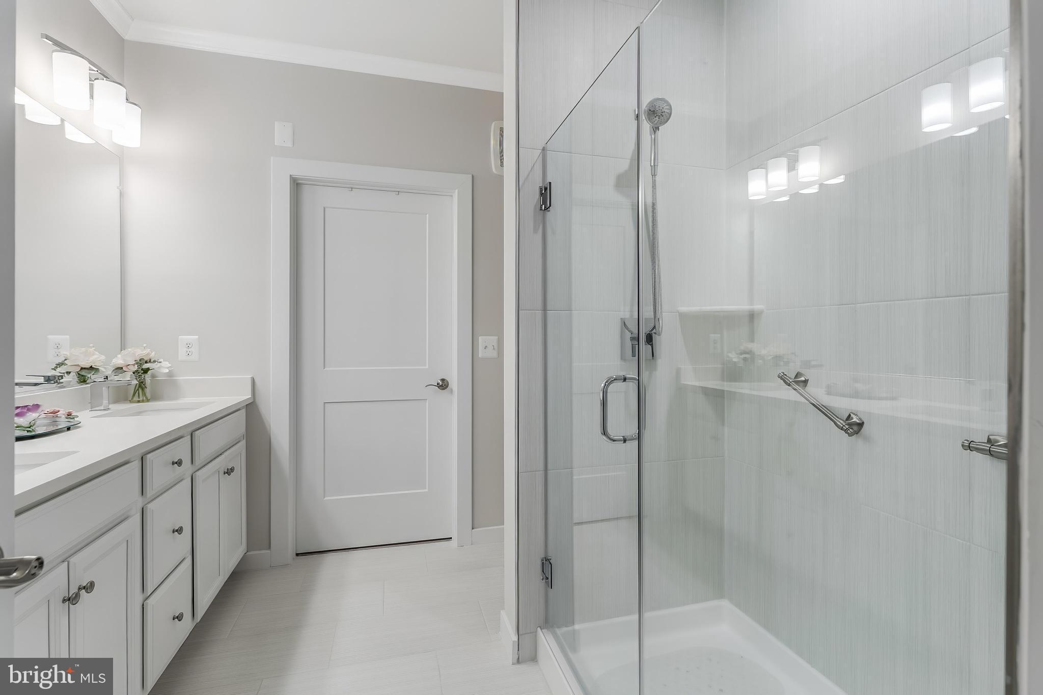 1675 Bandit Loop, Unit 105B Reston, VA 20190 - Photo 15 of 27 a bathroom with a shower sink and mirror