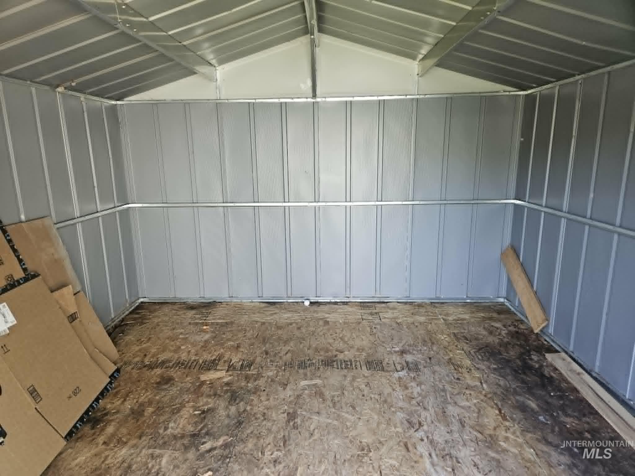 461 Greenleaf Street Boise, ID 83713 - Photo 17 of 19 Interior storage structure featuring corrugated metal walls and ceiling, exposed metal framing, and a wood-finish floor