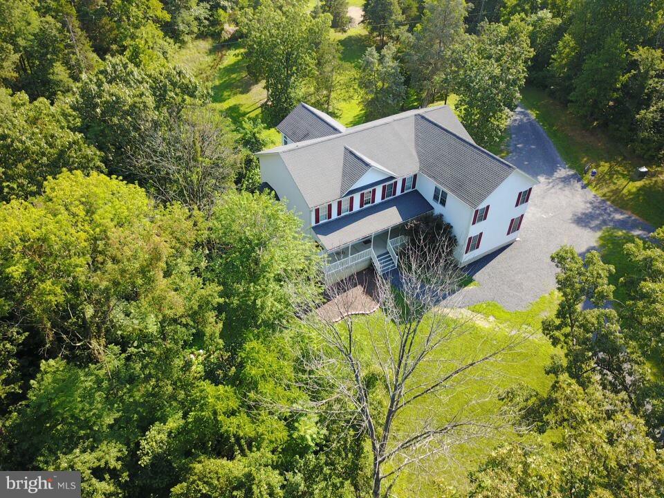 410 Old Kitchen Road White Post, VA 22663 - Photo 2 of 27 an aerial view of a house with swimming pool and lawn chairs under an umbrella
