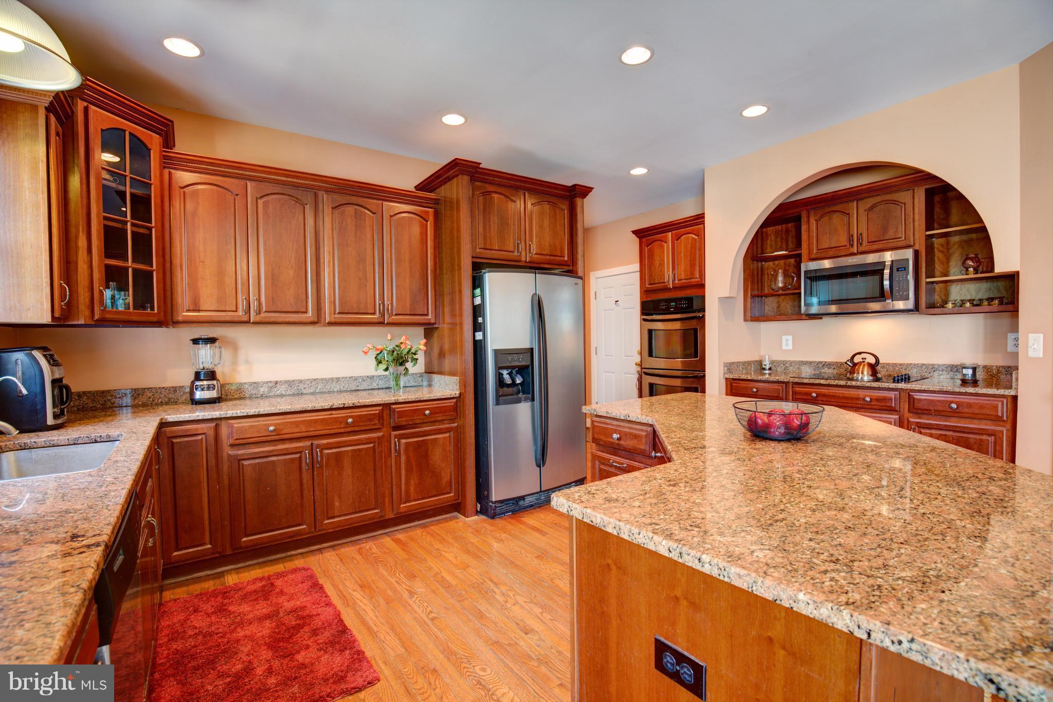 410 Old Kitchen Road White Post, VA 22663 - Photo 11 of 27 a kitchen with stainless steel appliances granite countertop a stove a sink and a refrigerator