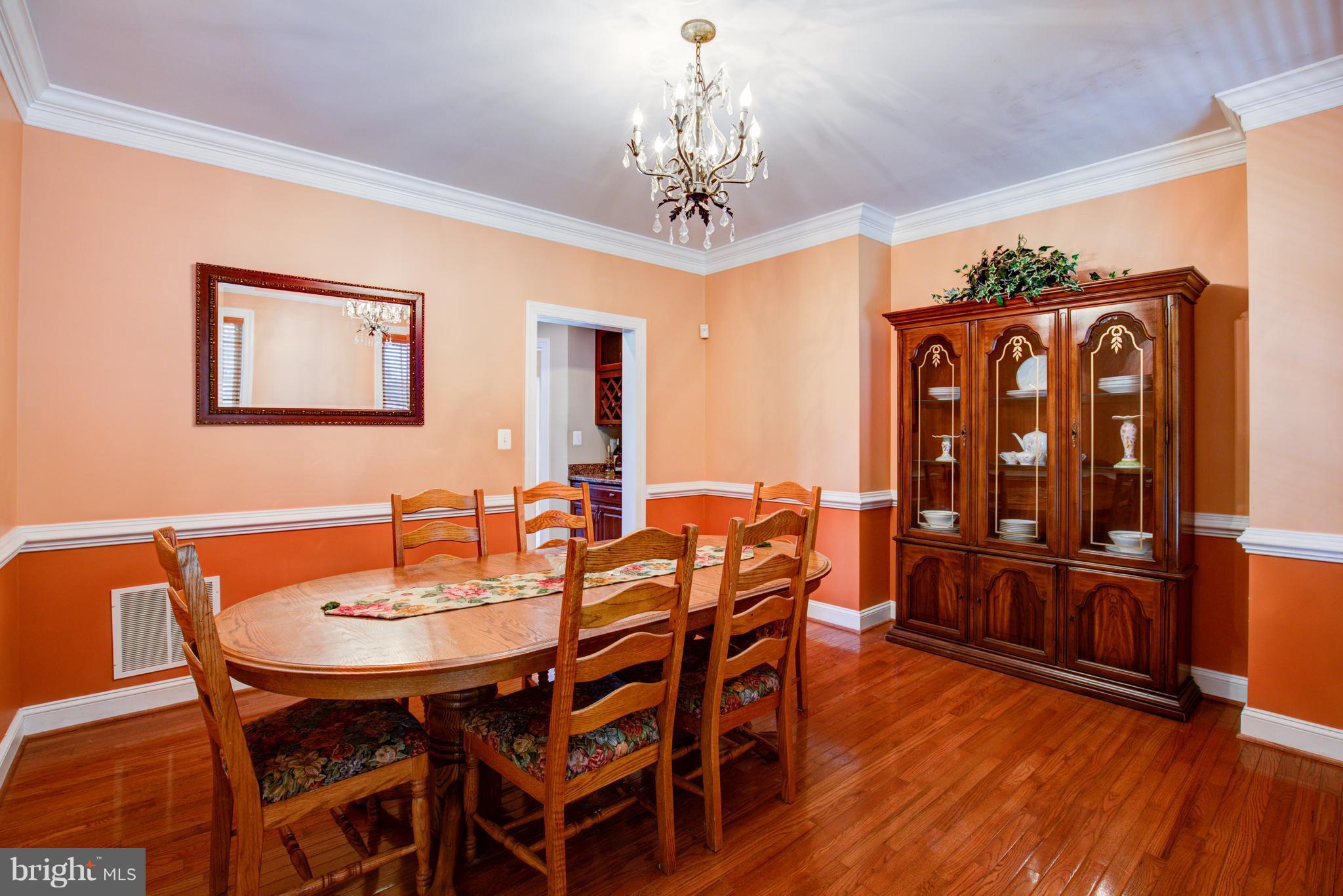 410 Old Kitchen Road White Post, VA 22663 - Photo 15 of 27 a view of a dining room with furniture wooden floor and chandelier
