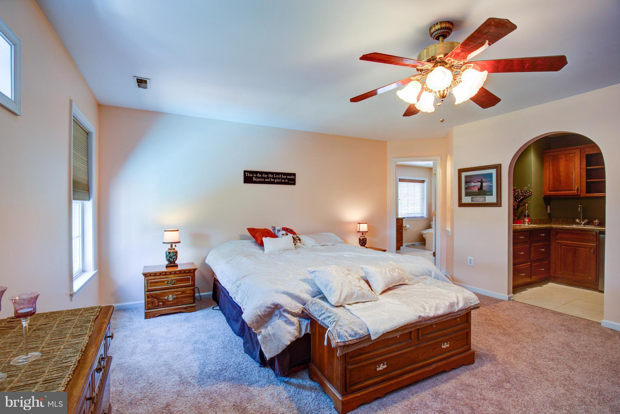 410 Old Kitchen Road White Post, VA 22663 - Photo 18 of 27 a bedroom with a bed and a chandelier
