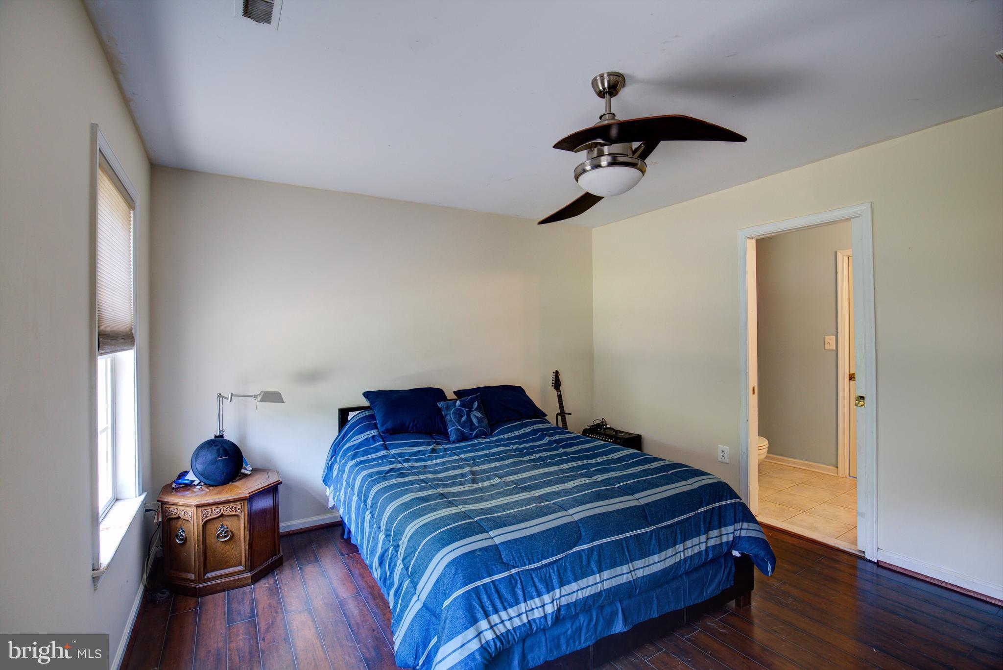 410 Old Kitchen Road White Post, VA 22663 - Photo 23 of 27 a bedroom with a bed and wooden floor